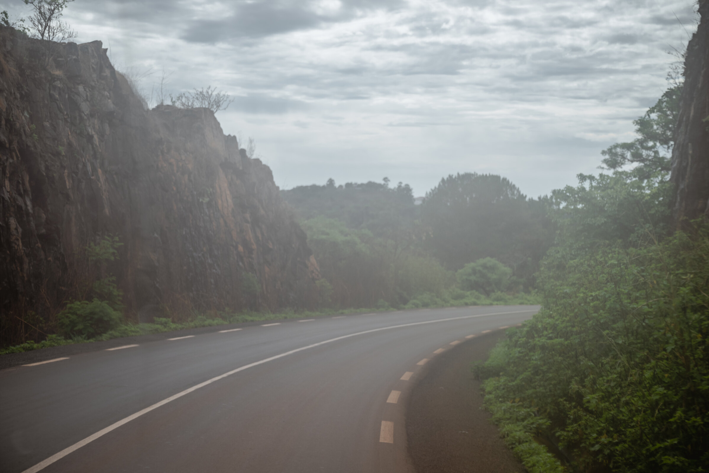 A misty paved road curve in West Cameroon